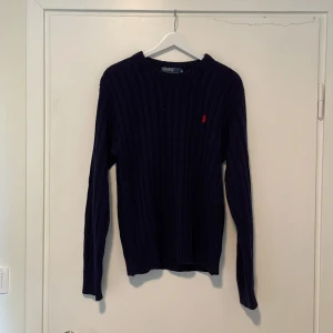 Ralph lauren kabelstickad tröja - Säljer nu min skitsnygga Ralph lauren tröja. Tröjan är i bra skick och har inga defekter. Den är perfekt för de lite kallare sommardagarna.🥂🍾