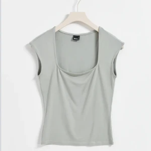 Topp - En super söt topp från Gina tricot i färgen Grön. Lite svårt att se den faktiska förgen på bild. Endast använd en gång, storlek S