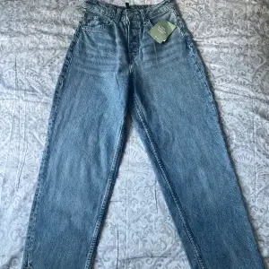 Högmidjade divided jeans från H&M i nyskick som aldrig använts med prislappen kvar.