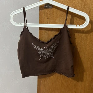 Topp - Brun croppad topp med en fjäril på i silver/glitter paljetter🤎 Nyskick!