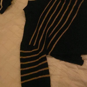 Stickad tröja - En stickad tröja i fint skick. Slits i sidorna och stora armar. Liten polokrage. (Allt görs fint och höras av innan jag skickar)💕priset är diskuterbart