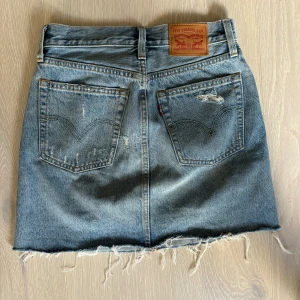Jeanskjol från levis - Säljer denna snygga jeanskjol från levis som är något längre  Den är i st xs men passar s också