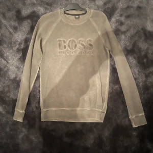 Hugo Boss sweatshirt - Storlek M, väldigt bra skick, är mer mörk/oliv grön i verkligheten och inte så ljus som på bild. 
