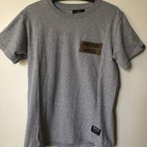 Neighborhood / NBHD Izzue Army T-Shirt  Size tag medium, but fits like a men’s small tee.  Great condition, no flaws or damage.  DM if you need exact size measurements.   Buyer pays for all shipping costs. All items sent with tracking number.   No swaps, no trades, no offers. 