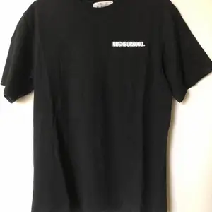 Neighborhood / NBHD Back Logo T-Shirt  Size tag large, but fits like a men’s small tee.  Great condition, no flaws or damage.  DM if you need exact size measurements.   Buyer pays for all shipping costs. All items sent with tracking number.   No swaps, no trades, no offers. 