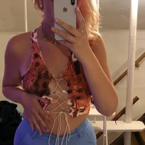 Söt topp - Jättesöt topp som endast är testad så helt oanvänd. cool design där man knyter i fram å kan välja då lite hur tajt den ska vara. 