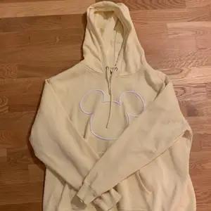 Yellow Micky mouse hoodie with a hood and pockets in the front