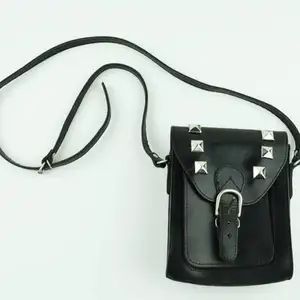 Liten svart väska med silvriga nitar. Lång men justerbar axelrem och tidlös design. Tillhör kollektionen Gossip Girl och idén till väskan är inspirerad av karaktären Jenny Humphrey’s stil.