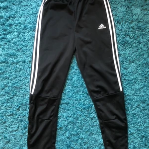 Adidas byxor - Snygga adidasbyxor med lös passform och resår i midjan. Fint skick, säljer då de inte kommer till andvändning. De har en dragkedja längst ner på benen och snöre i midjan. Skriv om ni har några frågor eller vill ha fler bilder. Frakt tillkommer, priset går att diskutera