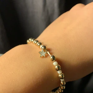 Armband - Vitt och guld med en stjärna i mitten