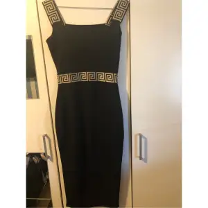 Snygg svart midi klänning, från Bohooo som är slut såld på sidan, med versace mönster. Kommer sälja massa klackskor. Jackor osv Köparen står för frakt