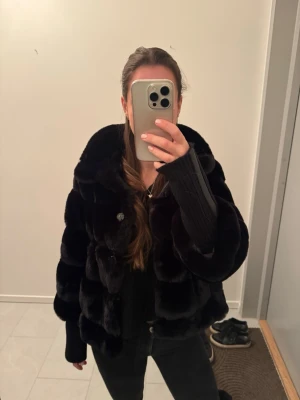 Svart pälsjacka med stora krage - Snygg svart pälsjacka med trekvarts armar med stickad arm nertill som även går att ta av! Köpt för 2500kr från Jackie och den är helt oanvänd med alla lappar kvarn