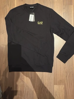 EA7 Armani Tröja  - Tjena, säljer min helt nya tröja som jag fick i present för länge sen. Inte sätt den ligga i garderoben, nu är den liten på mig. Helt ny verkligen. 