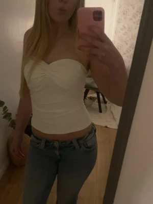 Vit tubtopp - Hej💗 jag säljer denna vita tubtoppen med scrunch på bröstet och scrunch i midjan. Säljer pågrund av att den inte används! Helt nytt skick💗skriv om ni har några frågor!