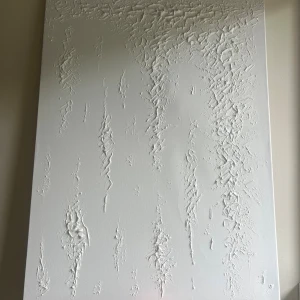 Canvas  - Bilden visar en vit canvas med upphöjd, strukturerad yta och abstrakta mönster. 