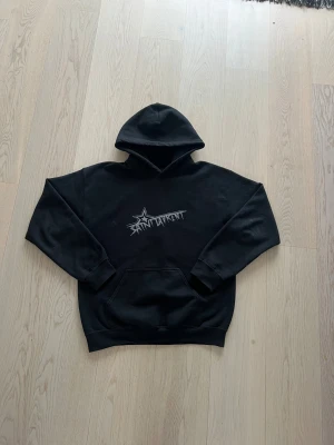 Saint Laurent hoodie - Svart hoodie från Saint Laurent tryck på bröstet. Snöret har lossnat men fås med.