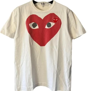 Vit Comme des Garçons Play t-shirt L - Säljer en vit t-shirt från Comme des Garçons Play i storlek L.  Klassisk passform och tillverkad i 100% bomull. Perfekt statement-plagg. STORLEK L MEN PASSAR MER M. Priset ej superfast så kom med bud. DM om du har frågor!