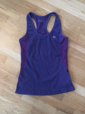 Lila träningslinne - Snyggt lila träningslinne från SOC med brottarrygg och diskret logga på bröstet.