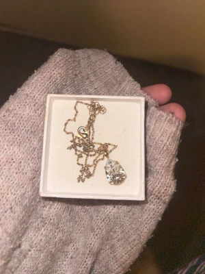 Caroline Svedbom halsband  - Stenen har rört sig lite som man kan se på bild. Original kedjan tappade färg har bytt till annan kedja (ej äkta guld). Nypris 895kr. Vit sten.