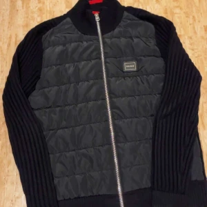Svart Hugo Boss cardigan - Mycket fin hugo boss cardigan som är använd i knappt 1 månad. Original pris 4000 mitt pris 1200. Säljs pga att jag behlver pengar snabbt så pris kan diskuteras!