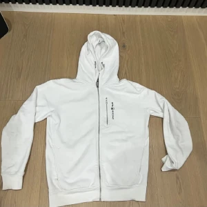 Sailracing Zip hoodie nyskick - Säljer min Sail Racing zip-hoodie i nyskick, endast använd ett fåtal gånger. Den har en skön passform och är tillverkad i material av hög kvalitet. Inga fläckar, noppor eller tecken på slitage, hoodien ser ut som ny. Perfekt för dig som vill ha en snygg och bekväm tröja från ett premiumvarumärke.