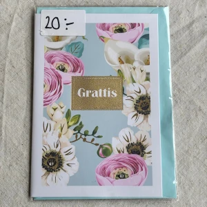 Gratulationskort  - Ett stilrent och färgglatt gratulationskort med blommotiv. Medföljer kuvert samt den är kvar i sin ursprungliga förpackning. Insidan består av helt vita blad så plats för mycket text 