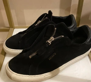 Svarta Arigato sneakers i mocka - Köptes på vinted. Oanvända av mig. Säljes för samma pris. Var för stora för mig och upplevs breda. Om man är bredfotad så är dem bra. 