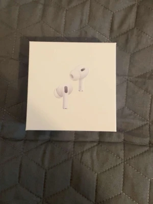 AirPods Pro 2 - Säljer ett par Apple AirPods Pro i mycket fint skick, komplett med originalförpackning, laddningskabel och laddningsetui. Hörlurarna fungerar utmärkt och har aktiv brusreducering samt transparensläge. Perfekt för både musik och samtal. Inga synliga defekter eller slitage.