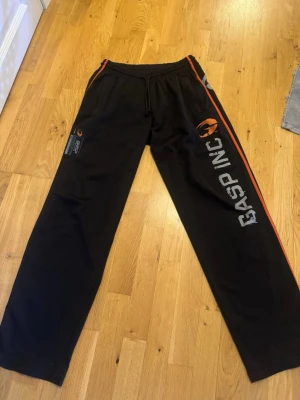 GASP träningsbyxor - Gasp träningsbyxor som i överlag är i gott skick förutom att det finns ett hål längst ner på vänstra benet. Man ser även på högra benet längst ner att byxorna har varit använda