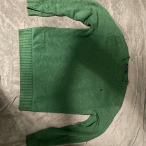 Grön stickad tröja från Polo Ralph Lauren - Snygg grön stickad tröja från Polo Ralph Lauren i storlek M. Tröjan har rund hals, ribbade muddar och det klassiska broderade Polo-logot på bröstet. Perfekt för dig som gillar stilrena och tidlösa plagg med premiumkänsla. Är också öppen för att byta med en annan färg 🎨