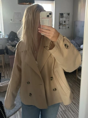 Beige trenchcoat - Beige trenchcoat från H&M, mest använd vid festtillfällen och därför säljer jag billigt då den ser lite använd ut men inte mycket☺️Jackan är i storlek L men passar mig lite oversized som vanligtvis har S i jackor:)