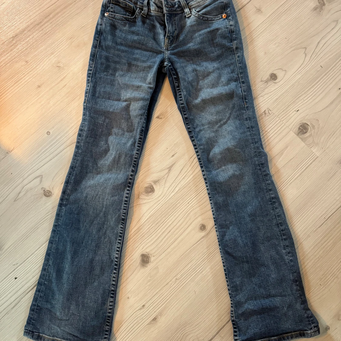 Blå bootcut jeans med broderad ficka