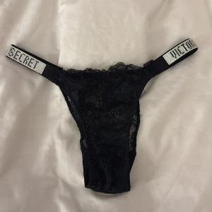 Svarta spets-trosor Victoria's Secret - !Aldrig använda! Svarta spets-trosor från Victoria's Secret med glittriga band. Det sitter fortfarande plast kvar på dom. Små i storlek, så egentligen en S