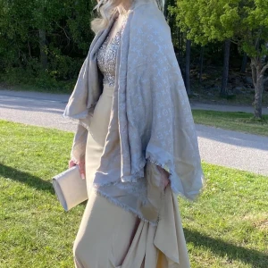 Balklänning - Säljer min balklänning i champagnefärg med glittrig, paljettbeströdd överdel med släp. Använd 1 gång. Hör av dig för fler bilder.