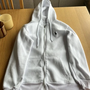 Vit hoodie från Polo Ralph Lauren - Vit hoodie från Polo Ralph Lauren med klassisk svart logo på bröstet