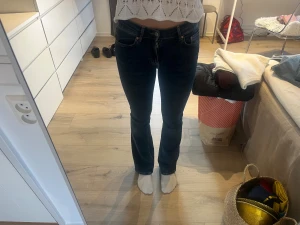 Gina tricot bootcut jeans mörkblå strl 34 - Säljer ett par klassiska Gina tricot jeans i mörkblå tvätt med bootcut passform. Snygga raka ben med lätt utsvängning och normal midja. Perfekta till sneakers eller boots. 