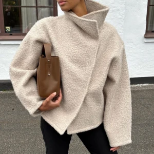 Teddyjacka - Supersnygg beige Teddyjacka ifrån Ginatricot. Man kan ha den både hög i kragen, men även nedvikt som på sista bilden. Knäppningen går lite snett vilket jag personligen ÄLSKAR med denhär jackan. Den är varm och mysig perfekt nu till höst/vinter💗💗 Heeelt slutsåld. Nypris: 600 kr