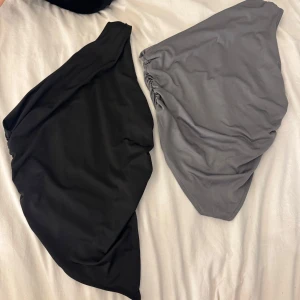 Svart och grå topp - Två snygga toppar i svart och grått med asymmetrisk form och rynkade detaljer på sidan. 