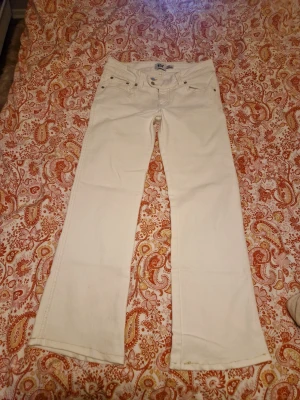 Vita bootcut jeans från lager 157 - Snygga vita jeans från lager 157 med bootcut-modell och broderad detalj på bakfickan. Klassisk femficksdesign och raka ben. Perfekta för dig som vill sticka ut med stilrena detaljer och ljus färg. Har kortat ner dem så skriv om ni vill ha mått.