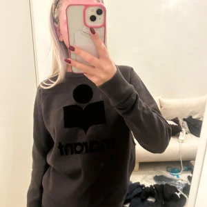 Brun sweatshirt Isabel Marant - Säljer en brun sweatshirt från Isabel Marant Étoile med stor svart logga framtill. Tröjan har rund hals, långa ärmar och är tillverkad i mjukt material som känns skönt mot huden. Perfekt för dig som gillar stilrena och coola designer. Storlek 38 men skulle säga att den passar XS/S