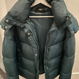 Grön dunjacka från Bik Bok - Säljer min gröna jacka från bikbok. Väldigt populär och säljs inte längre. Storlek XS men lite oversized i storleken 