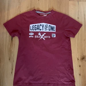 Röd t-shirt från My Wear Man Departement  - Snygg röd t-shirt köpt på secondhand. Perfekt för en avslappnad stil. Jag är 186cm och brukar köpa S eller M. 