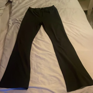 Svarta bootcut byxor - Snygga svarta bootcut byxor, midwaist. Perfekta för en stilren look och passar till många olika outfits. Byxorna har en klassisk design och är tillverkade i ett bekvämt material.