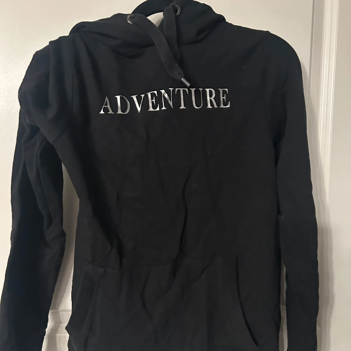 Svart hoodie med texten 'ADVENTURE'
