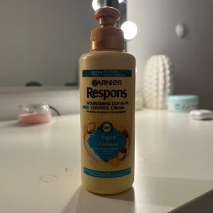 Garnier Respons Nourishing Leave-In Control Cream - En närande leave-in kräm från Garnier Respons, perfekt för att kontrollera frissigt hår. Innehåller arganolja och mandelkräm för att ge mjukhet och glans.  Perfekt för daglig användning för att hålla håret mjukt och hanterbart.