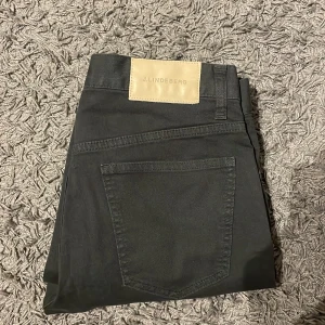 Svarta byxor från J.Lindeberg - Säljer ett par snygga svarta byxor från J.Lindeberg. De har en klassisk design med en bakficka och en diskret logga på baksidan. Perfekta för både vardag och fest!