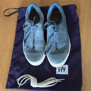 Blå sneakers från Eytys - Säljer ett par snygga blå sneakers från Eytys i mocka. De är köpte på plick och är i bra skick!! Däremot så vet jag ej var de tillhöriga vita snörena är. Skriv om ni har några frågor