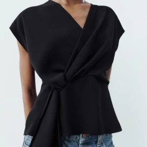 Svart omlottopp - svart omlottopp med en knytning i midjan.  Aldrig använd med prislapp kvar. Nypris 329