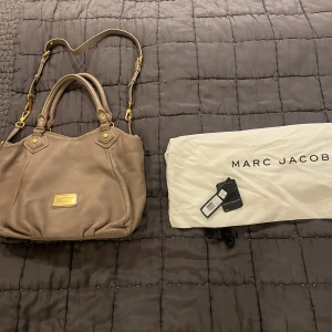 Marc jacobs väska  - Hejsa! Säljer nu en jättefin beige Marc jacobs väska som inte kommer till användning. Dust bag och original prislappen följer med. Hör gärna av er vid frågor eller funderingar