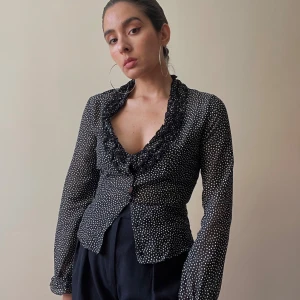 Vintage Stefanel Dot Print Top - Vintage 90s Style Stefanel Silk Ruffle Blouse with a Beautiful Delicate Flamenco Dotted Print. Ruffle Detail around Neckline & Cuffs for a Feminine Shape. Elastic Cuffs & 5 Fabric Covered Buttons. Some signs of wear in the ruffles but overall Great